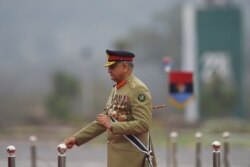 FILE - Pakistan Army Chief General Qamar Javed Bajwa arrives to attend the Pakistan Day parade, in Islamabad, March 23, 2019.