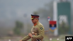 FILE - Pakistan Army Chief General Qamar Javed Bajwa arrives to attend the Pakistan Day parade, in Islamabad, March 23, 2019.