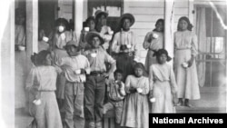 Patients at Tuberculosis Sanitorium with glasses of milk, Phoenix Indian School, c. 1890-1910. 