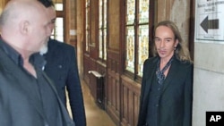 Former Dior designer John Galliano (R) arrives to face charges of using anti-Semitic slurs in a Paris cafe - allegations that shocked the fashion world and cost him his job at the renowned French high-fashion house Dior - at the Paris court house, June 22