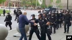 In this image from video provided by WBFO, a Buffalo police officer appears to shove a man who walked up to police June 4, 2020, in Buffalo, N.Y. 