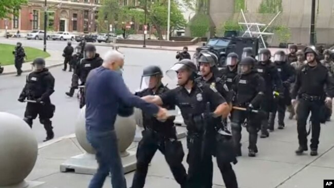 In this image from video provided by WBFO, a Buffalo police officer appears to shove a man who walked up to police June 4, 2020, in Buffalo, N.Y.