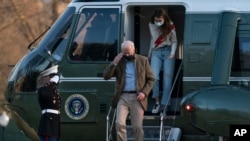 President Joe Biden, followed by his granddaughter Natalie Biden, disembark Marine One on the South Lawn upon arrival at the White House in Washington from a weekend trip to Wilmington, Del., March 14, 2021. 