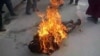 FILE - This still image allegedly shows the self-immolation of an individual along a street in Dawu, Ganzi prefecture in Sichuan province.