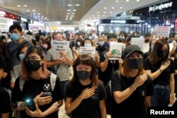Anti-government protesters sing a protest song "Glory to Hong Kong" during a sit-in at Yoho mall, at Yuen Long MTR station, in Hong Kong, China September 21, 2019. REUTERS/Tyrone Siu