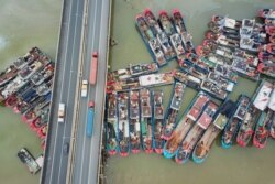 FILE - This aerial image shows fishing boats docked on the last day of the summer fishing moratorium, as they prepare to leave port in Lianyungang in eastern China's Jiangsu province.