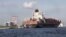 Commerce department report indicates U.S. businesses boosted inventory to spur better-than-expected growth. Above, a container ship on its way to unload its cargo at Port Everglades in Fort Lauderdale, Florida, Sept. 27, 2012.