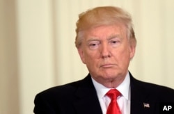 President Donald Trump listens while attending an event in the State Dining Room of the White House in Washington, May 12, 2017.