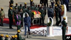 A coffin carrying the body of Zimbabwe's former ruler Robert Mugabe arrives from Singapore, at the RG Mugabe International Airport in Harare, Kenya. Wednesday Sept. 11, 2019. T