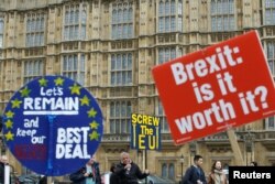 FILE - Pro-Brexit and anti-Brexit protesters are pictured outside the Houses of Parliament in London, Britain, March 27, 2019.
