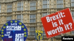 FILE - Pro-Brexit and anti-Brexit protesters are pictured outside the Houses of Parliament in London, Britain, March 27, 2019.