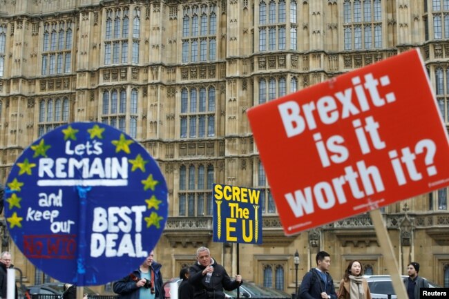 FILE - Pro-Brexit and anti-Brexit protesters are pictured outside the Houses of Parliament in London, Britain, March 27, 2019.