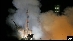 The Soyuz-FG rocket booster with Soyuz TMA-12M space ship carrying a new crew to the International Space Station (ISS) blasts off at the Russian leased Baikonur cosmodrome, Kazakhstan, March 26, 2014.