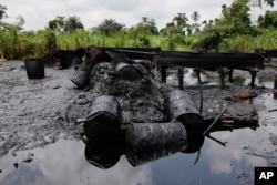 FILE - An abandoned illegal refinery is seen at the creeks of Bayelsa, Nigeria, May 18, 2013.