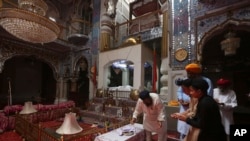 People from Pakistan Sikh community visit their temple in Peshawar, Pakistan, Aug. 8, 2017. Today Sikhs are battling with the Pakistan government for ownership of dozens of Sikh temples that they call gurdwaras and while it is slow going they have managed to reclaim some of their temples. Many were abandoned in 1947 and taken over by Muslims who arrived from India. The Pakistan government, which took over the buildings after 1947, allowed the squatters to remain. 
