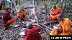 Venerable But Buntenh, top right, eats alongside other monks during a forest patrol in Prey Roka forest, Preah Vihear province, Cambodia, October 7, 2016 (Courtesy photo of Bun Buntenh)