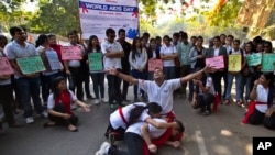 Students in New Delhi, India, prepare a street play about HIV and AIDS to mark World AIDS Day, Monday, December 1, 2014. (AP Photo/Saurabh Das)