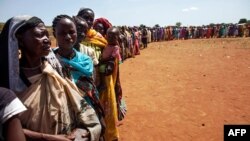 FILE - Internally displaced people, who recently arrived in Wau, South Sudan, due to armed clashes in surrounding villages, wait to be registered by the International Organization for Migration and the World Food Program, May 11, 2016.