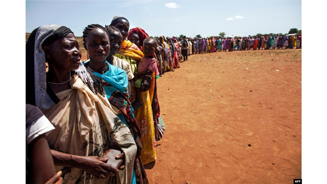 FILE - Internally displaced people, who recently arrived in Wau, South Sudan due to armed clashes in surrounding villages, wait to be registered by the International Organization for Migration and the World Food Program, May 11, 2016.
