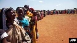 FILE - Internally displaced people wait to be registered by the International Organization for Migration and the World Food Program, in Wau, South Sudan, May 11, 2016. The U.S. accuses the South Sudanese government of "choosing arms systems over food for their people."