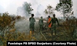 Unsur gabungan BPBD dan TNI memadamkan api di sekitar kawasan bandara Syamsuddin Noor, Banjarbaru, 15 September 2018. (Foto courtesy: Pusdalops PB BPBD Banjarbaru).