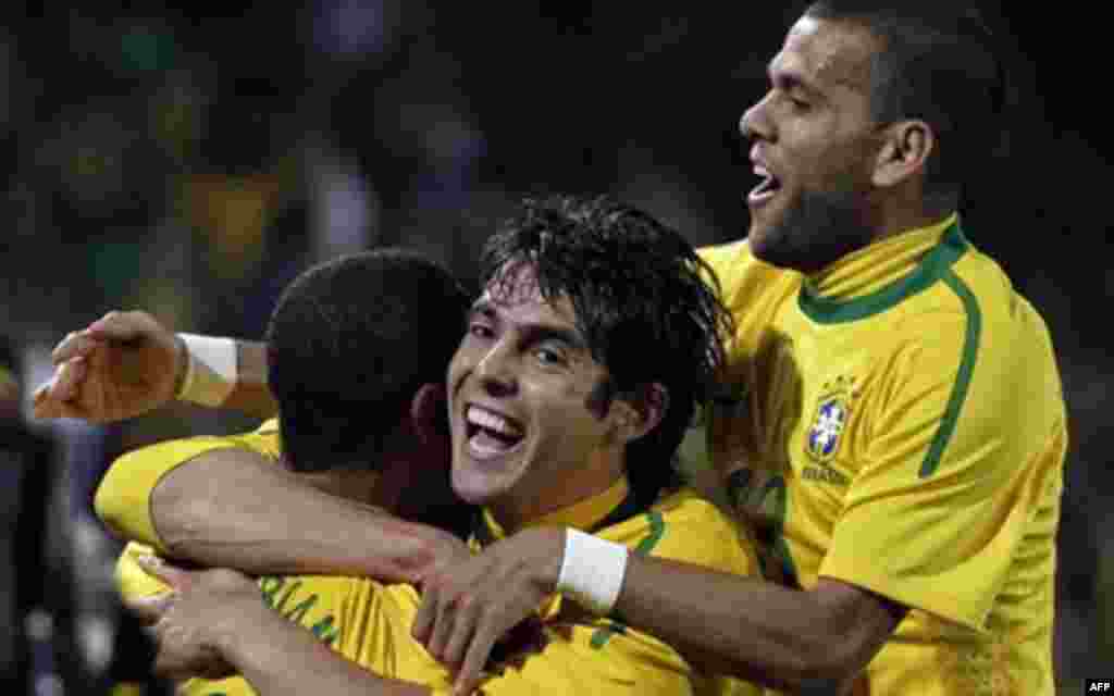 Brazil's Luis Fabiano, left, celebrates with Brazil's Kaka, center, and Brazil's Daniel Alves after scoring the second goal during the World Cup round of 16 soccer match between Brazil and Chile at Ellis Park Stadium in Johannesburg, South Africa, Monday,