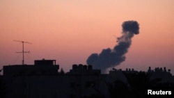 FILE - Smoke rises following an Israeli airstrike in the Gaza Strip, June 20, 2018. Israeli strikes killed two Palestinians on Wednesday. 