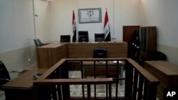 FILE - An empty courtroom is seen at Nineveh Criminal Court, one of two counterterrorism courts in Iraq where suspected Islamic State militants and their associates are tried, in Tel Keif, Iraq, April 26, 2018.