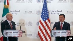 U.S. Homeland Security Secretary John Kelly, left, listens to Mexico's Interior Secretary Miguel Angel Osorio Chong as he gives a statement to the press after Kelly's visit in Mexico City, July 7, 2017.