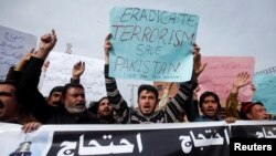 Protesters hold placards and chant slogans against the recent bomb blasts in various parts of Pakistan during a protest in Peshawar, Pakistan February 17, 2017.