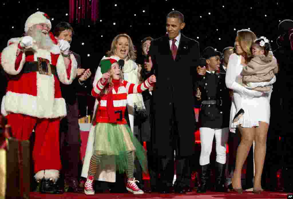 El presidente baila junto a una niña, Santa Claus y las cantantes Janelle Monáe y Mariah Carey y su hija, Monroe, al final de la ceremonia.