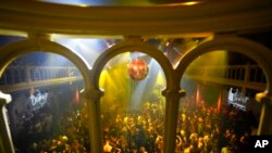 People dance in close proximity at Paradiso pop venue, club and cultural center, in Amsterdam, Sept. 25, 2021, the day the Netherlands dropped the coronavirus-related 1.5-meter distancing rule.