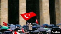 FILE - Wives and relatives of retired and active military officers charged in the so-called Sledgehammer trial hold a protest at Anitkabir, the mausoleum of Mustafa Kemal Ataturk, founder of secular Turkey, in Ankara, Feb. 19, 2011. 