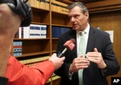 FILE - Former Kansas Secretary of State Kris Kobach answers questions from reporters in Topeka, Kansas, Nov. 30, 2018.