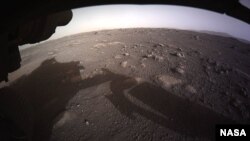 NASA released this photo as the first high-resolution, color image to be sent back by the Hazard Cameras (Hazcams) on the underside of the Perseverance rover after its landing on Mars. (NASA)