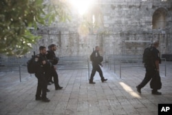 Israeli police officers walk outside the Al-Aqsa Mosque compound in Jerusalem's Old City, July 25, 2017.