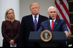 FILE - President Donald Trump, joined by Homeland Security Secretary Kirstjen Nielsen, left, listens to Vice President Mike Pence speak in the Rose Garden of the White House in Washington after a meeting with Congressional leaders on border security, Jan. 4, 2019.