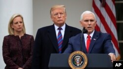 President Donald Trump joined by Homeland Security Secretary Kirstjen Nielsen, left, listens to Vice President Mike Pence speaks in the Rose Garden of the White House in Washington after a meeting with Congressional leaders on border security, Jan. 4, 201