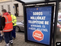 FILE - A poster in Budapest reads 'Soros would settle millions from Africa and the Middle East. Stop Soros!,' Feb. 1, 2018.