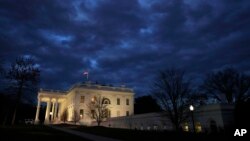 In this Jan. 8, 2019, photo, clouds roll over the White House in Washington. Just 21 of the roughly 80 people who help care for the White House - from butlers to electricians to chefs - are reporting to work. The rest have been furloughed.