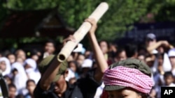 Cambodian students re-enact torture executed by the Khmer Rouge to mark the annual "Day of Anger" at Choeung Ek, a former Khmer Rouge "killing field" dotted with mass graves about nine miles (15 kilometers) south of Phnom Penh.