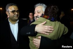 FILE - Murat Sabuncu, editor-in-chief of the newspaper Cumhuriyet, is greeted by his friends after being released from the prison in Silivri near Istanbul, Turkey, March 10, 2018.