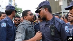 Maldivian opposition supporters scuffle with security forces officers during a protest demanding the release of political prisoners in Male, Maldives, Feb. 2, 2018.