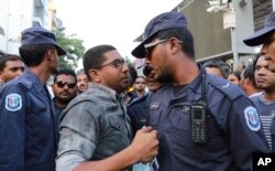 Maldivian opposition supporters scuffle with security forces officers during a protest demanding the release of political prisoners in Male, Maldives, Feb. 2, 2018.