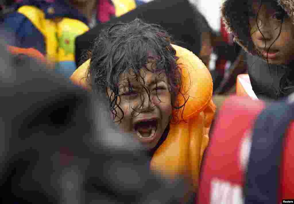 More Syrian refugees arrive on the shores of the Greek island of Lesbos after crossing the Aegean Sea from Turkey on an inflatable dinghy.