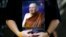 FILE - A man holds a portrait of Thailand's Supreme Patriarch, Somdet Phra Nyanasamvara Suvaddhana Mahathera, at Chulalongkorn Hospital in Bangkok, October 25, 2013. 