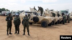 Rwandan peacekeepers from the Rwanda Defence Force (RDF) check their armored personnel carriers (APC) before a parade in Juba, South Sudan, August 8, 2017. 