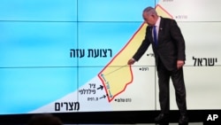 Israeli Prime Minister Benjamin Netanyahu stands before a map of the Gaza Strip, explaining that Israel must retain control over the "Philadelphi corridor," a strategic area on the border with Egypt, during a news conference in Jerusalem, Sept. 2, 2024.