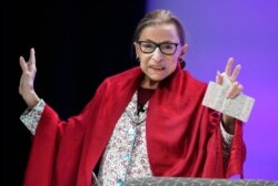 FILE - U.S. Supreme Court Justice Ruth Bader Ginsburg gestures to students before she speaks at Amherst College in Amherst, Mass., Oct. 3, 2019.