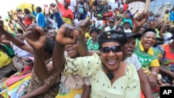 FILE: Women chant party slogans upon the arrival of Zimbabwean President Robert Mugabe for a crucial Zanu PF Poltiburo meeting in Harare, Wednesday Feb. 10, 2016. Mugabe addressed thousand of party supporters and chaired a bitterly divided Zanu pf Politiburo amid heightened tensions over issues to do with factionalism and succession in the party.(AP Photo/Tsvangirayi Mukwazhi)